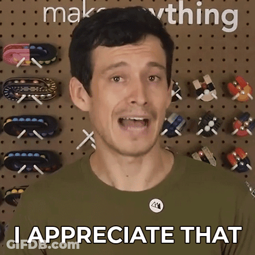 A Man Says " I Appreciate That " In Front Of A Wall Full Of Toys GIF
