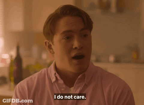 A Man Says I Do Not Care In A Pink Shirt GIF
