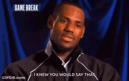 A Man Says I Knew You Would Say That In Front Of A Blue Curtain GIF