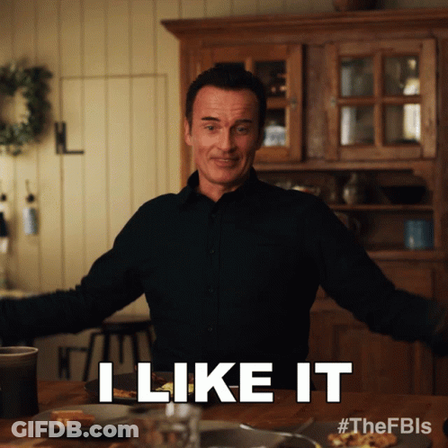 A Man Says I Like It While Standing In Front Of A Table GIF