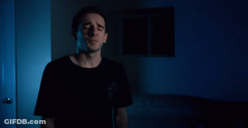 A Man Says I 'Ll Be Back In Front Of A Blue Background GIF