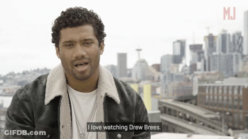 A Man Says I Love Watching Drew Brees In Front Of A City Skyline GIF