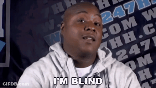 A Man Says I 'M Blind In Front Of A Banner With The Number 247 On It GIF