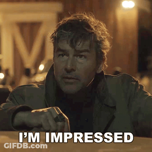 A Man Says I 'M Impressed In Front Of A Sign That Says M GIF