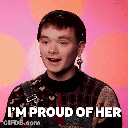 A Man Says I 'M Proud Of Her While Wearing A Sweater And Overalls GIF