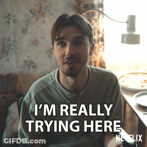 A Man Says I 'M Really Trying Here While Sitting At A Table GIF