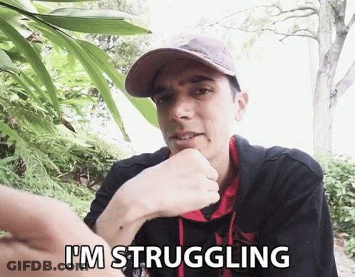 A Man Says I 'M Struggling In Front Of A Tree GIF