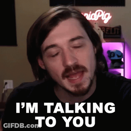 A Man Says I 'M Talking To You In Front Of A Sign That Says Pig GIF