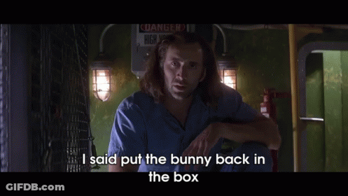 A Man Says I Said Put The Bunny Back In The Box In Front Of A Danger Sign GIF