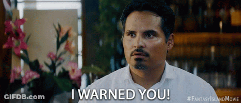A Man Says " I Warned You " In Front Of Flowers GIF