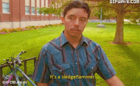 A Man Says It 'S A Sledgehammer In Front Of A Bike GIF