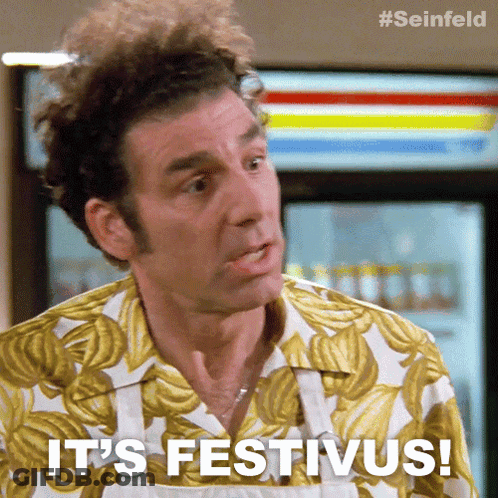 A Man Says It 'S Festivus While Wearing A Banana Print Shirt GIF