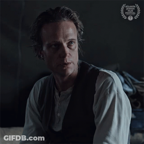 A Man Says Just Tell Me While Sitting In A Dark Room GIF