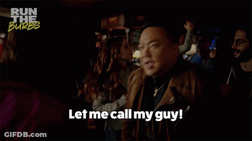 A Man Says " Let Me Call My Guy " In A Crowd GIF