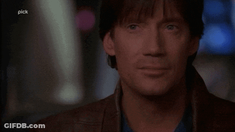 A Man Says " Let 'S Bring It " In Front Of A Dark Background GIF