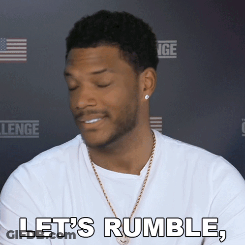 A Man Says Let 'S Rumble In Front Of A Challenge Sign GIF