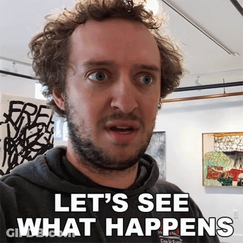 A Man Says Let 'S See What Happens In Front Of A Wall Of Paintings GIF