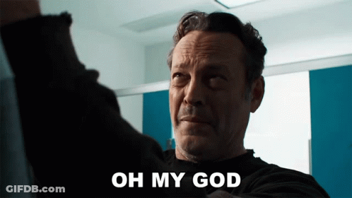 A Man Says Oh My God In Front Of A Blue And White Wall GIF