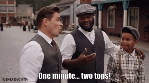 A Man Says One Minute Two Tops In Front Of Two Other Men GIF