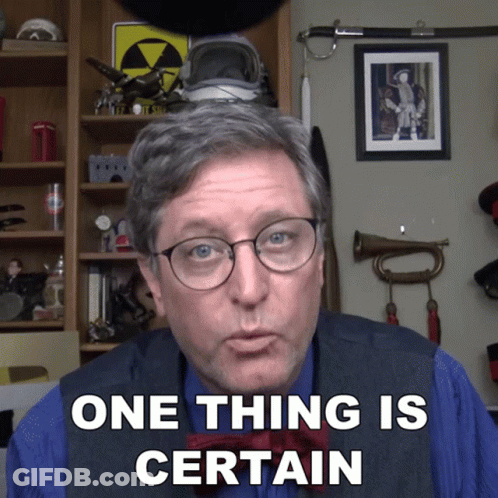 A Man Says One Thing Is Certain In Front Of A Shelf GIF