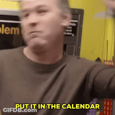 A Man Says Put It In The Calendar In Front Of A Yellow Wall GIF