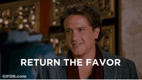 A Man Says Return The Favor In Front Of A Wall GIF