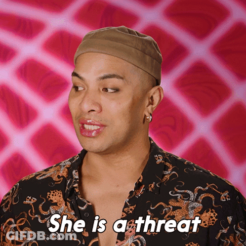 A Man Says She Is A Threat With A Pink Background GIF