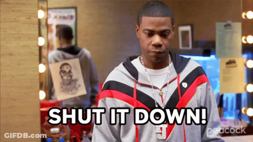 A Man Says Shut It Down In Front Of A Peacock Logo GIF
