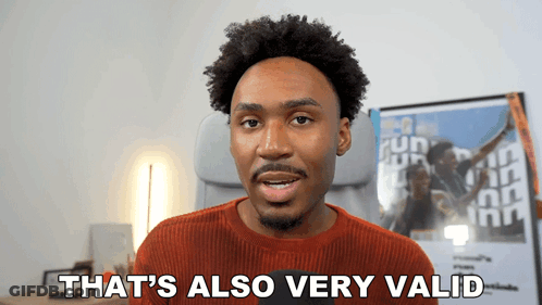 A Man Says " That 'S Also Very Valid " In Front Of A Poster GIF