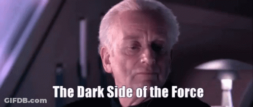 A Man Says The Dark Side Of The Force In A Dark Room GIF