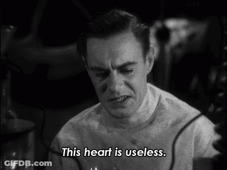 A Man Says " This Heart Is Useless " In A Black And White Scene GIF