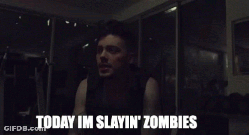 A Man Says " Today Im Slayin ' Zombies " In A Dark Room GIF