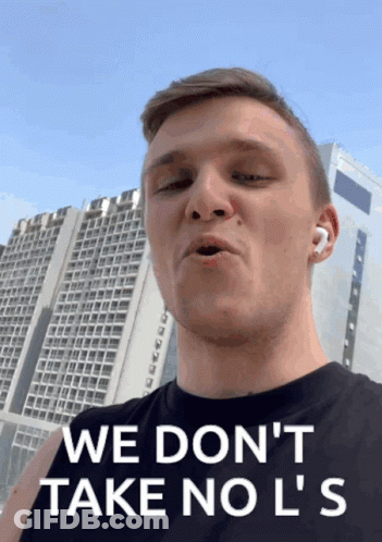 A Man Says " We Don 'T Take No L 'S " In Front Of A Tall Building GIF