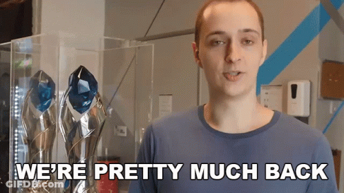 A Man Says We 'Re Pretty Much Back While Standing In Front Of Trophies GIF