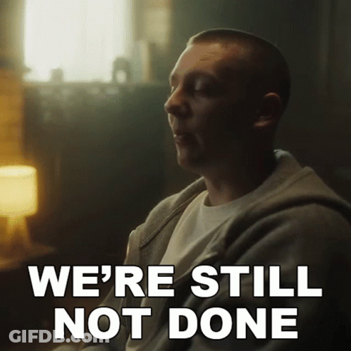 A Man Says We 'Re Still Not Done While Sitting In A Dark Room GIF