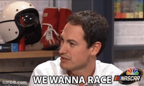 A Man Says We Wanna Race In Front Of Nascar Helmets GIF