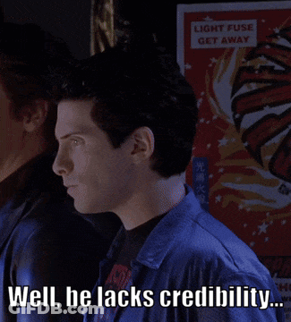 A Man Says Well He Lacks Credibility In Front Of A Sign That Says Light Fuse Get Away GIF