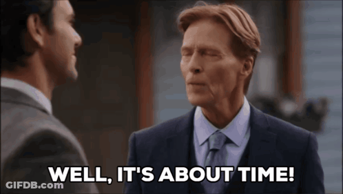 A Man Says Well It 'S About Time While Talking To Another Man GIF