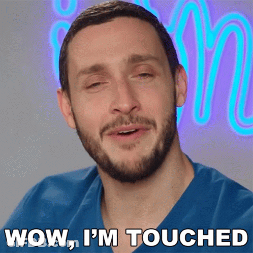 A Man Says Wow I 'M Touched In Front Of A Neon Letter M GIF
