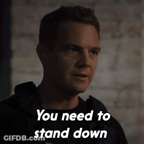 A Man Says You Need To Stand Down In Front Of A Wall GIF