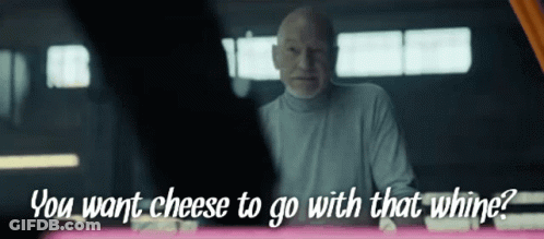 A Man Says " You Want Cheese To Go With That Whine " While Looking At Another Man GIF