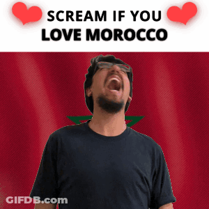 A Man Screaming In Front Of A Morocco Flag GIF