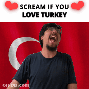 A Man Screams In Front Of A Turkey Flag GIF