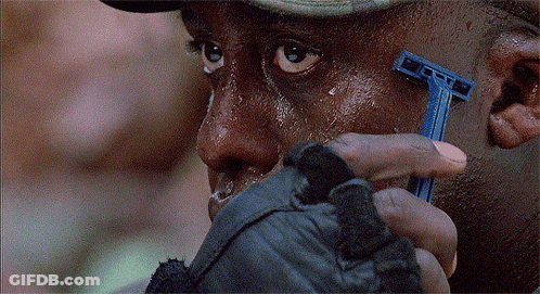 A Man Shaves His Face With A Blue Razor That Says Gillette On It GIF