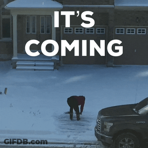 A Man Shoveling Snow In Front Of A House With The Words It 'S Coming Above Him GIF