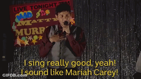 A Man Singing In Front Of A Live Tonight Banner GIF