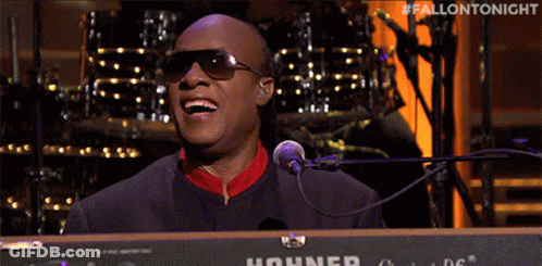 A Man Singing Into A Hohner Keyboard With The Hashtag #Fallontonight GIF