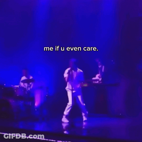 A Man Singing Into A Microphone On A Stage With The Words Me If U Even Care On The Bottom GIF