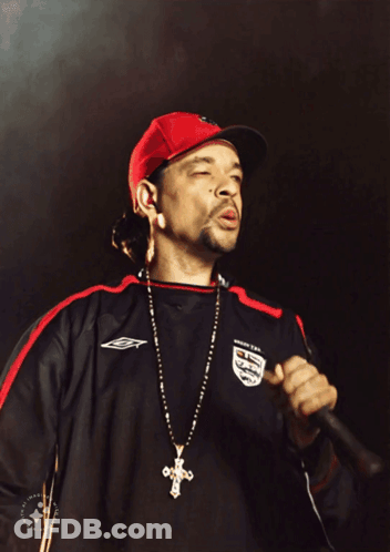A Man Singing Into A Microphone Wearing A Jersey That Says England On It GIF