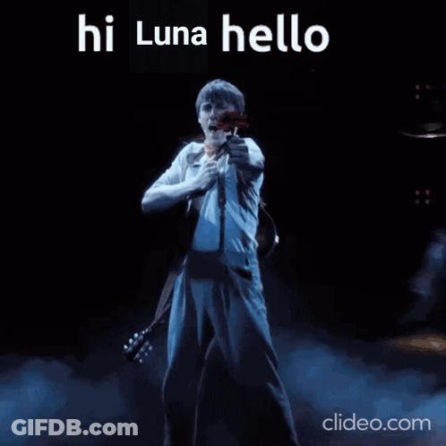 A Man Singing Into A Microphone While Holding A Red Rose With The Words Hi Luna Hello Written Above Him GIF